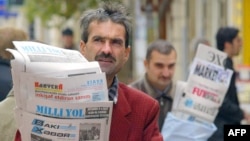 FILE - Azeri street vendors sell papers in downtown Baku, in November 2005. In the years since, the country’s print media have almost disappeared, but Azerbaijan is seeing a growth in online media. 