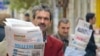 FILE - Azeri street vendors sell papers in downtown Baku, in November 2005. President Ilham Aliyev on Sept. 26, 2022, signed off on new “rules for maintaining a media registry” in the country.  