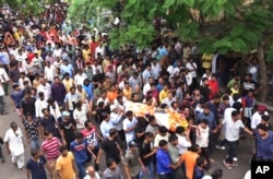People participate in the funeral procession of tailor Kanhaiya Lal in Udaipur, India, June 29, 2022. The Hindu man was stabbed multiple times inside his tailoring shop Tuesday by two cleaver-wielding men who also filmed the attack, news agency Press Trust of India reported.