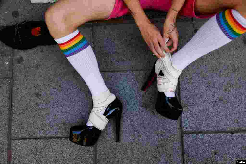 A person prepares for the start of the yearly race on high heels during Gay Pride celebrations in the quarter of Chueca in Madrid, Spain.