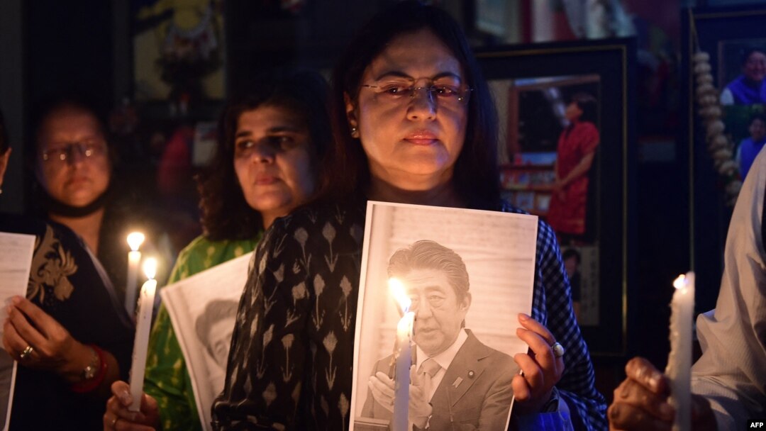 Members of the Japan information and study center hold a candlelight vigil to pay tribute to the late former prime minister of Japan, Shinzo Abe, at Ahmedabad Management Association in Ahmedabad, India, July 9, 2022.