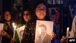 Members of the Japan information and study center hold a candlelight vigil to pay tribute to the late former prime minister of Japan, Shinzo Abe, at Ahmedabad Management Association in Ahmedabad, India, July 9, 2022.