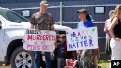 A family of abortion opponents stand outside the Jackson Women's Health Organization clinic in Jackson, June 25, 2022.