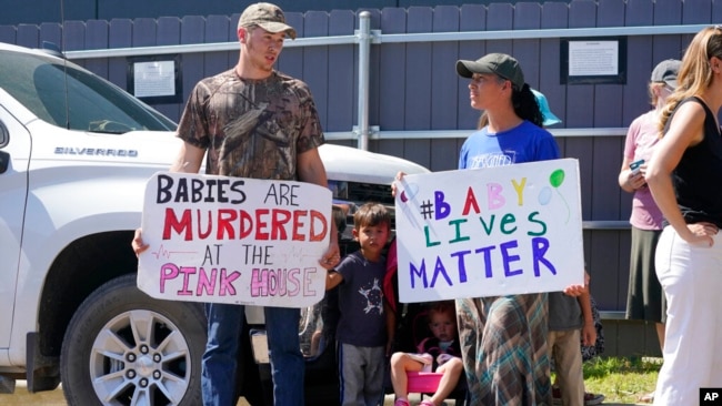 A family of abortion opponents stand outside the Jackson Women's Health Organization clinic in Jackson, June 25, 2022.