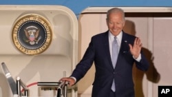 President Joe Biden waves as he leaves Air Force One after arriving at Franz-Josef-Strauss Airport near Munich, Germany, June 25, 2022, ahead of the G7 summit.