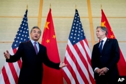 U.S. Secretary of State Antony Blinken, right, and China's Foreign Minister Wang Yi attend a meeting in Nusa Dua on the Indonesian resort island of Bali, July 9, 2022.