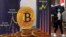 In this file photo, an advertisement for Bitcoin cryptocurrency is displayed on a street in Hong Kong on Feb. 17, 2022. (AP Photo/Kin Cheung, File)