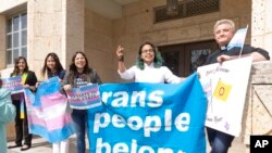 FILE - Adri Perez, ACLU of Texas Policy and Advocacy Strategist, center, and other LGBTQ leaders speak outside the Travis County courthouse March 2, 2022, in Austin. Texas.