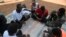 FILE: Sudanese asylum seeker play poker outside their temporary houses at Gashora Emergency Transit Centre in Gashora, Rwanda, on June 25, 2022. The Gashora Emergency Transit Centre opened in 2019 following an agreement between Rwanda, UNHCR, and the African Union.