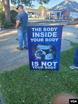 A sign held by protestors outside a Baton Rouge abortion center on the day Lighthouse Christian Fellowship Church attended.