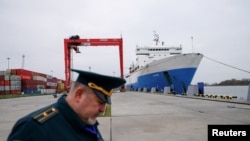 FILE - A Russian customs officer works at a commercial port in the Baltic Sea town of Baltiysk in the Kaliningrad region, Russia, Oct. 28, 2021.