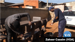 Hudson Diphofa and a worker work on outdoor furniture made from plastic waste