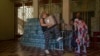 An elderly woman receives humanitarian food aid from the Kramatorsk city council, eastern Ukraine, July 7, 2022.