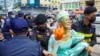 FILE - Cambodian-US human rights advocate Theary Seng, dressed as Lady Liberty, is arrested by police after being found guilty of treason in her trial in front of the Phnom Penh municipal court on June 14, 2022. (Photo by Samuel / AFP)