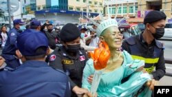 FILE - Cambodian-US human rights advocate Theary Seng, dressed as Lady Liberty, is arrested by police after being found guilty of treason in her trial in front of the Phnom Penh municipal court on June 14, 2022. (Photo by Samuel / AFP)