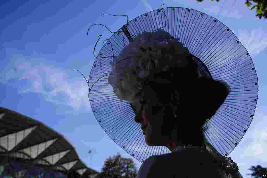A racegoer poses for a photo, on the second day of of the Royal Ascot horserace meeting, at Ascot Racecourse, in Ascot, England.