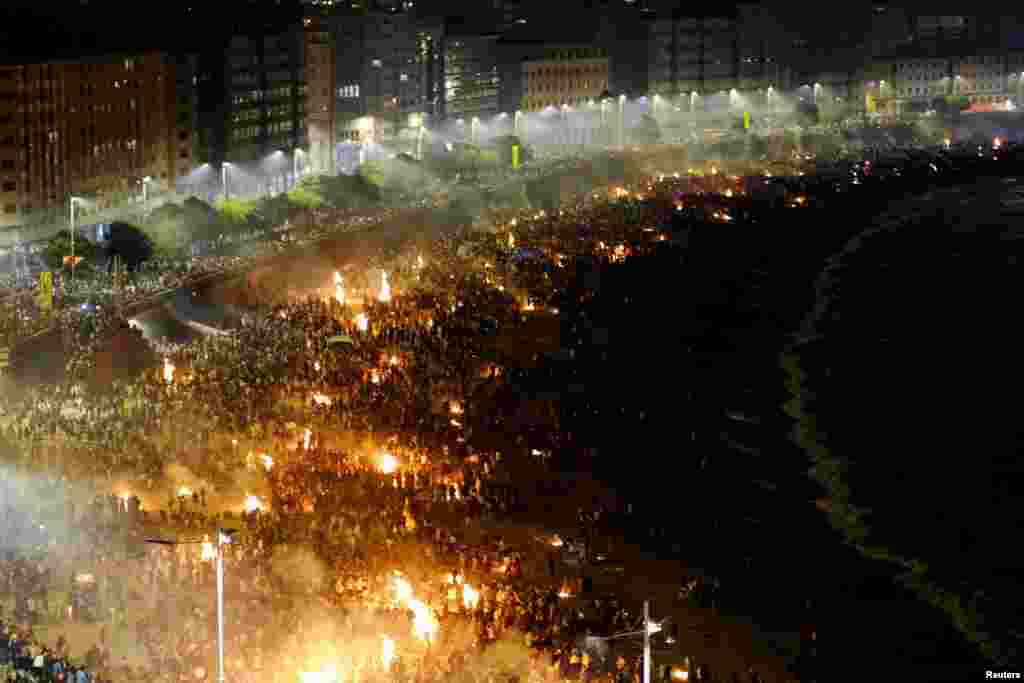 People celebrate St. John's night (San Juan) around bonfires on Orzan beach, in A Coruna, Spain.