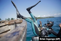 Coral reef restoration ranger Dosa Mshenga Mchambi heads into the Indian Ocean near Shimoni, Kenya on Tuesday, June 14, 2022. (AP Photo/Brian Inganga)