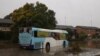 A bus inundated by floodwaters sits in the middle of a residential street, following heavy rains and severe flooding in the McGraths Hill suburb of Sydney, July 6, 2022.