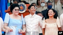President Ferdinand Marcos Jr. stands with his mother Imelda Marcos, left, and his wife Maria Louise Marcos, right, during the inauguration ceremony