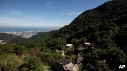Houses in the Enchanted Valley sustainable community stand on the outskirts of Tijuca National Forest in Rio de Janeiro, Brazil, June 6, 2022.