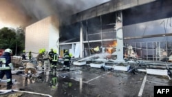 This handout picture taken and released by the Ukraine's State Emergency Service on June 27, 2022 shows firefighters putting out the fire in a mall hit by a Russian missile strike in the eastern Ukrainian city of Kremenchuk.