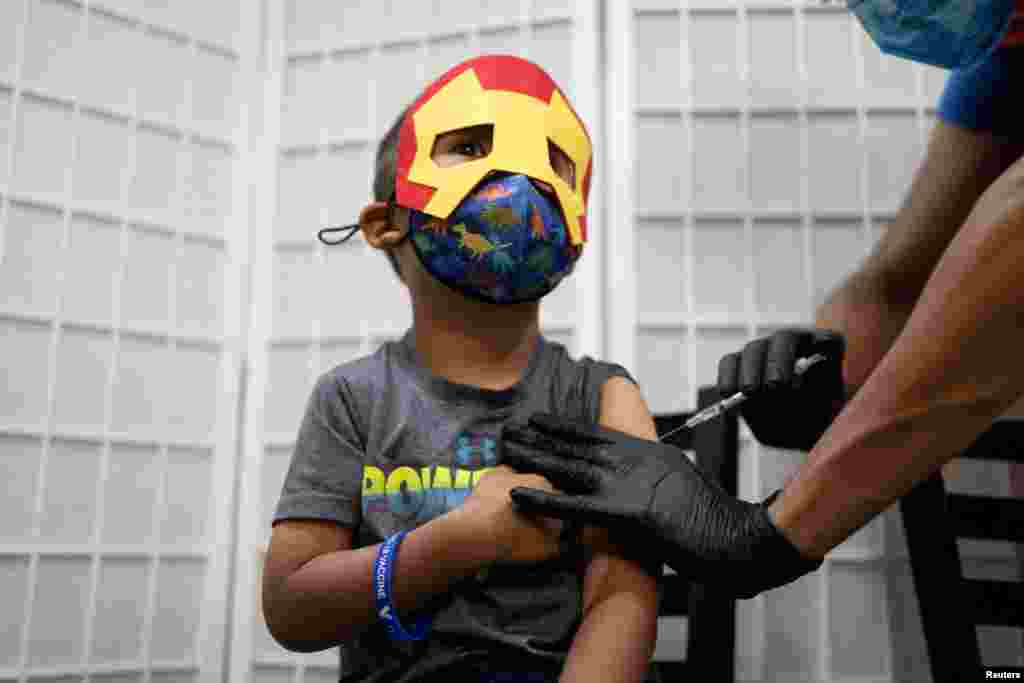 A 4-year-old receives a COVID-19 vaccine for children under five years old at Skippack Pharmacy in Schwenksville, Pennsylvania, June 21, 2022.