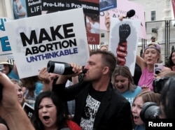 Anti-abortion demonstrators celebrate outside the United States Supreme Court as the court rules in the Dobbs v Women's Health Organization abortion case, overturning the landmark Roe v Wade abortion decision in Washington, U.S., June 24, 2022.