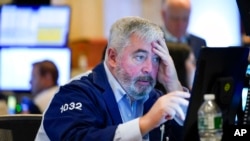 A trader works on the floor at the New York Stock Exchange in New York, June 16, 2022.