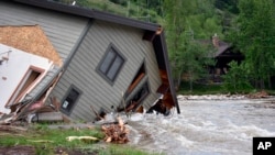 A House Pulled Into Rock Creek In Red Lodge, Mont., Is Seen By Floodwaters On June 14, 2022.