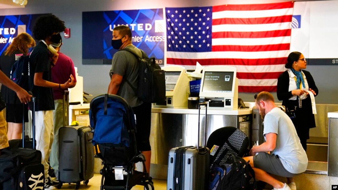 Travelers check in at the Philadelphia International Airport ahead of the Independence Day holiday weekend July 1, 2022. 