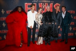 FILE - From left, Yola, Austin Butler, Olivia Dejonge, director Baz Luhrmann, Tom Hanks and Luke Bracey pose for photographers upon arrival for the premiere of the film 'Elvis' in London, Britain, May 31, 2022.