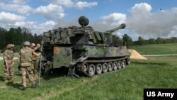 FILE - Ukrainian artillerymen fire a self-propelled howitzer during training at Grafenwoehr Training Area, Germany, May 12, 2022. The US is sending another $1 billion in military aid to Ukraine.