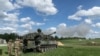 FILE - Ukrainian artillerymen fire a self-propelled howitzer during training at Grafenwoehr Training Area, Germany, May 12, 2022. The US is sending another $1 billion in military aid to Ukraine.