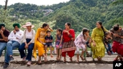 Tourists sit on public benches in Dharmsala, India, June 17, 2022. Summer travel is underway across the globe, but a full recovery from two years of coronavirus could last as long as the pandemic itself.