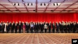 Chinese President Xi Jinping, center front, poses for a photo with central government officials based in Hong Kong and senior executives of Hong Kong branches of mainland enterprises and institutions, in Hong Kong, June 30, 2022. 