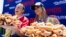 Joey Chestnut, left, and Miki Sudo pose with their winning totals of 63 (Chestnut) and 40 hot dogs after winning the Nathan's Famous Fourth of July hot dog eating contest in Coney Island on Monday, July 4, 2022, in New York.