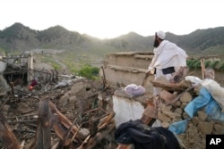 A man stands among destruction after an earthquake in Gayan village, in Paktika province, Afghanistan, June 23, 2022.