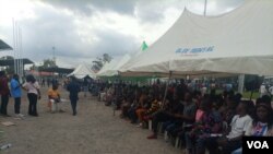 Crowds gather on the open field singing and dancing as Nigerian music stars serenade them with music and clear messages about voter registration onJune 25, 2022. (Timothy Obiezu/VOA)