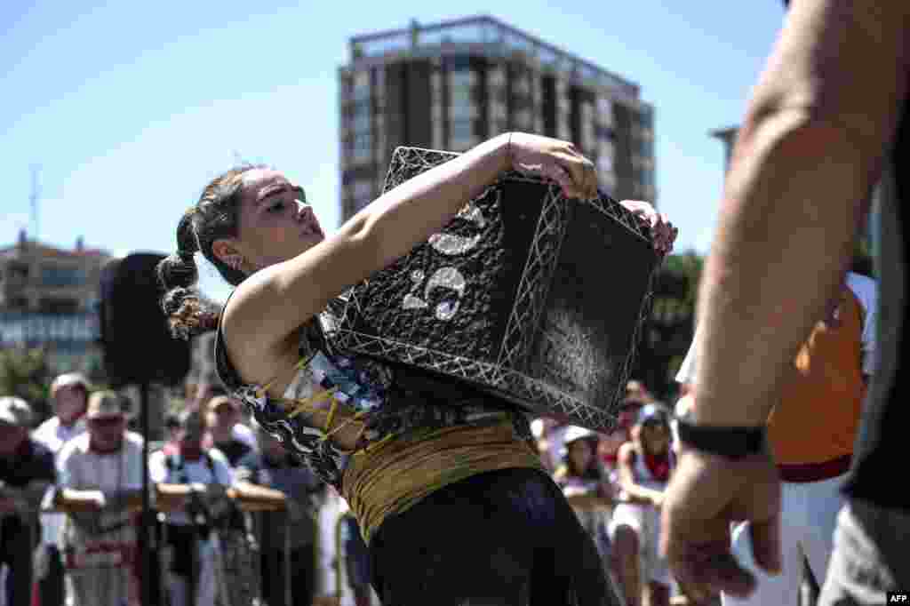 Basque &quot;Harrijasotzaile&quot; stone lifter Udane Ostolaza lifts a stone during the San Fermin Festival in Pamplona, northern Spain.