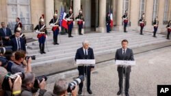 French President Emmanuel Macron, right, and Israel's Prime Minister Yair Lapid address journalists, July 5, 2022 at the Elysee Palace in Paris. It was Lapid's first overseas trip since he took office last week.