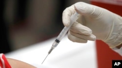 FILE - In this Jan. 23, 2020, photo, a patient gets an influenza vaccine in Mesquite, Texas. 