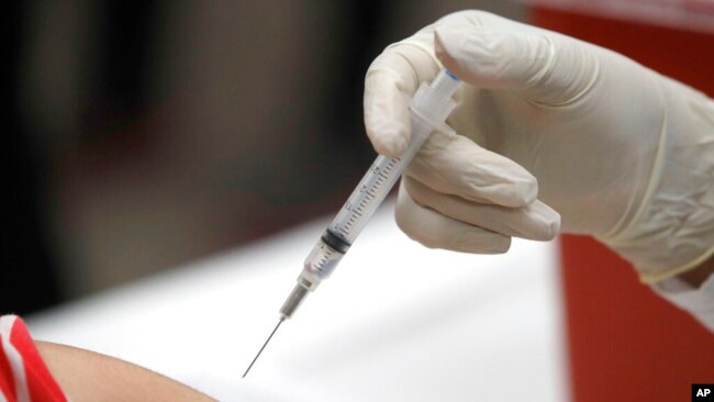 FILE - In this Jan. 23, 2020, photo, a patient gets an influenza vaccine in Mesquite, Texas.