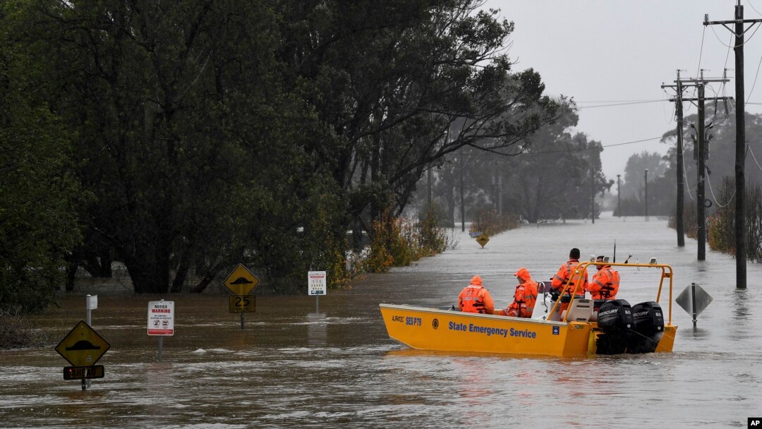 FILE - A New South Wales State Emergency Service crew is seen in a rescue boat as roads are submerged under floodwater from the swollen Hawkesbury River in Windsor, northwest of Sydney, July 4, 2022. 
