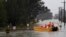 FILE - A New South Wales State Emergency Service crew is seen in a rescue boat as roads are submerged under floodwater from the swollen Hawkesbury River in Windsor, northwest of Sydney, July 4, 2022. 