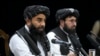 Zabiullah Mujahid, left, the spokesman for the Taliban government, speaks during a press conference in Kabul, Afghanistan, June 30, 2022.