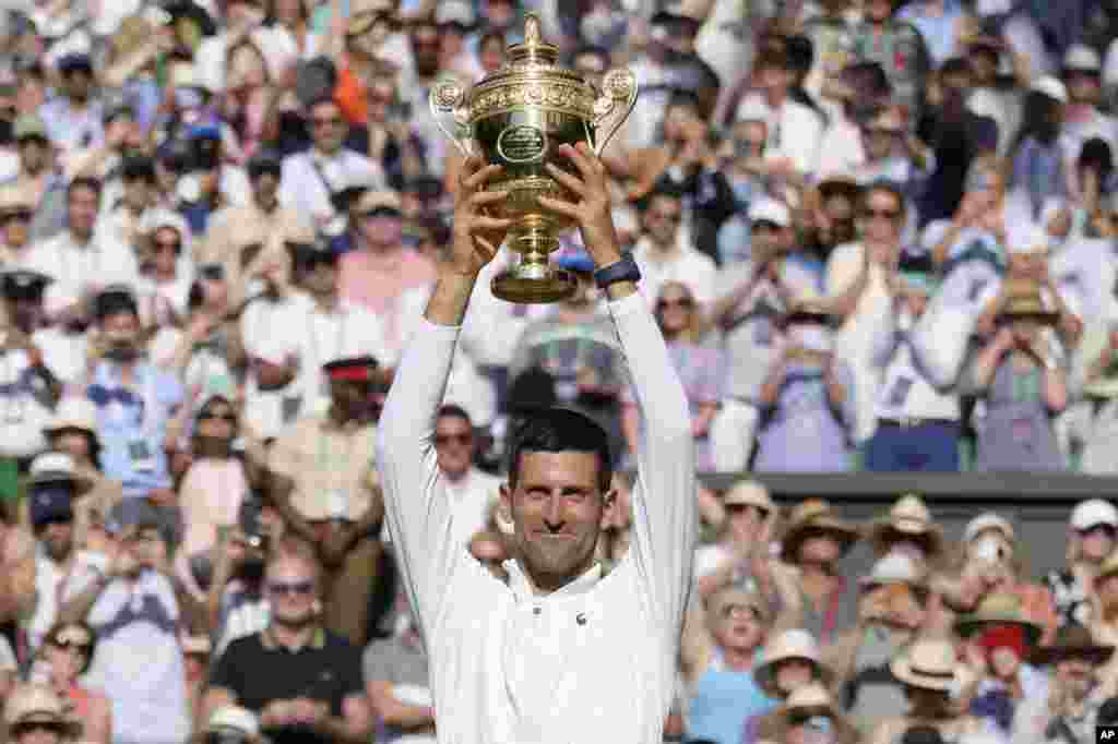 Serbia&#39;s Novak Djokovic celebrates beating Australia&#39;s Nick Kyrgios in the final of the men&#39;s singles on day fourteen of the Wimbledon tennis championships in London.