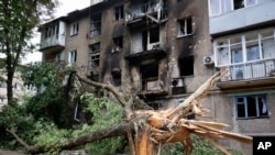 A view of an apartment building damaged during shelling in Donetsk, in territory under the government of the Donetsk People's Republic, eastern Ukraine, June 22, 2022. 