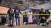 A relative of one of the 14 victims shot dead in a tavern in Soweto reacts next to the crime scene in Soweto on July 10, 2022.