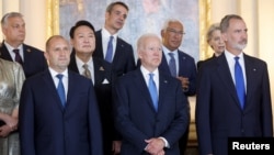 Spain's King Felipe poses for a family photo with US President Biden, Bulgaria's President Radev, South Korea's President Yoon Suk-yeol, European Commission President Ursula von der Leyen, and other leaders in Madrid, June 28, 2022.